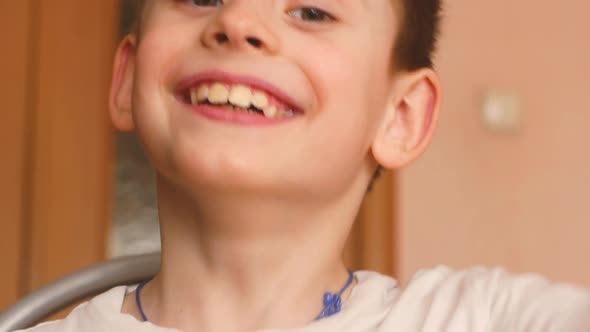 Funny Caucasian boy with a mustache mask and glasses jokes and laughs. Humor from a child parodying alt