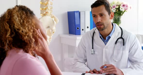 Patient suffering from pain while consulting Physiotherapist alt