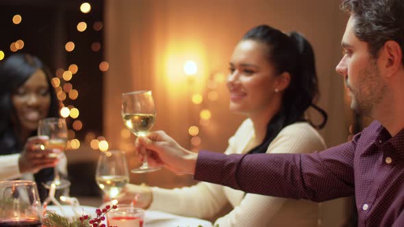 Happy Friends Having Christmas Dinner at Home alt