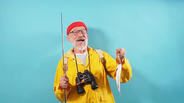 Happy Old Bearded Fisherman Is Happy As He Has Cought Fist Fish alt
