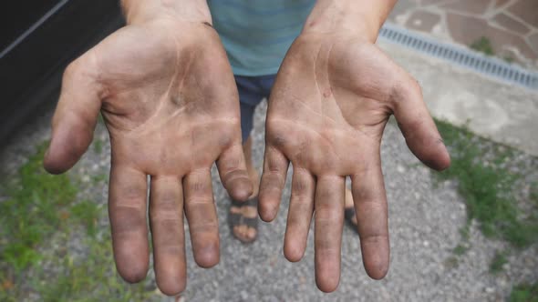 Mechanic Shows Hands in Fuel Oil After the Done Work alt