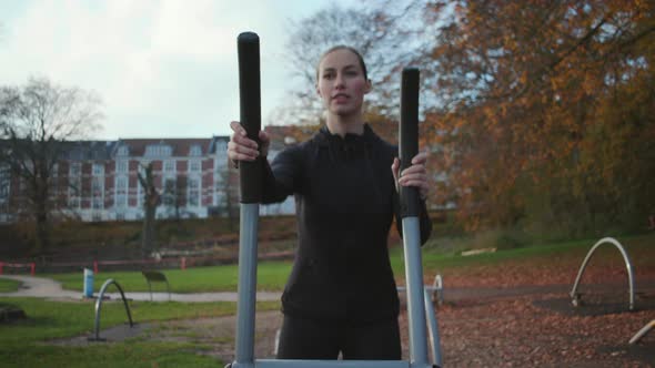 Beautiful Woman On Cross Trainer At Outdoor Gym alt