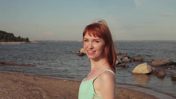 Beautiful Happy Girl Walking Along the Beach in a Good Mood alt