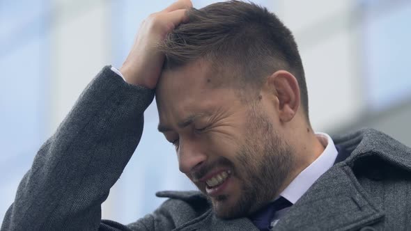 Man Clutching Head in Despair Close-Up, Feeling Guilty and Helpless, Burnout