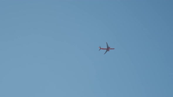 Plane Flying in Bright Blue Sky