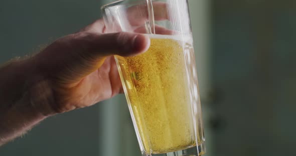 Glass of Beer in a Man's Hand