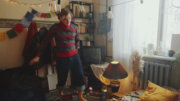 Young Couple Smoking and Reading Book at Home alt
