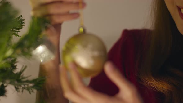 Asian female decorated with ornament on Christmas tree at Christmas night and New Year festival. alt