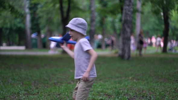 Boy Playing in the Park with a Toy Plane