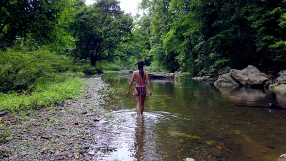 Young Woman in Bikini Walking in the River Thailand