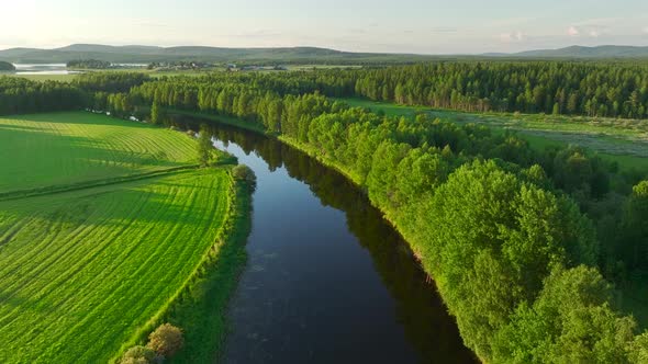 Aerial view of a river crossing the countryside, Overtornea, Sweden. alt