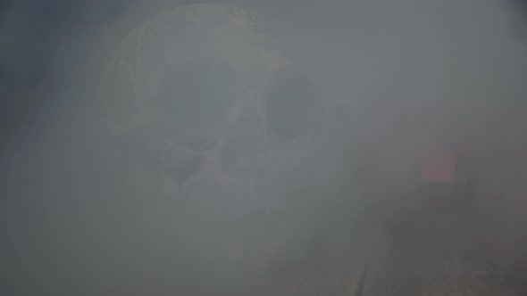 Smoke Clouds Are Hiding Skull and Pumpkin Standing at the Wooden Table alt