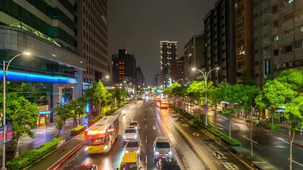 Traffic in Taipei City at Night in Taiwan. Timelapse of Transport Moving Along Illuminated Street alt