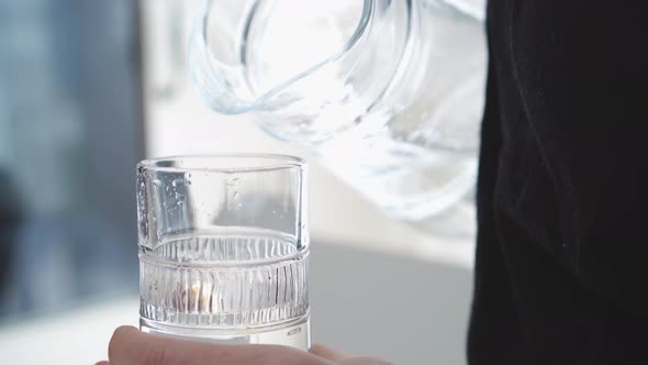 Hand with glass of water close up video 4k