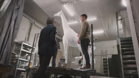 Entrepreneur Discussing Statue with Artisan alt