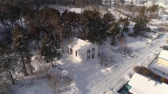 Drone shot of new white modern residential house at winter near the forest 07 alt