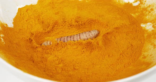 Turmeric, curcuma longa, Root falling on curcuma Powder, Indian Spice, Slow Motion 4K alt