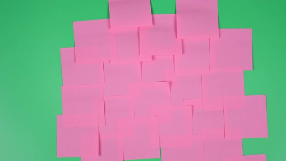 Many note paper on a green background - Stop Motion Animation.