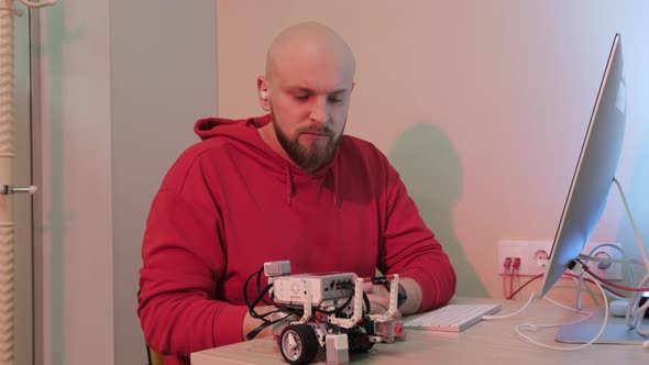 Close Up of an Young Man That is Learning Robotics Lessons Using Computer