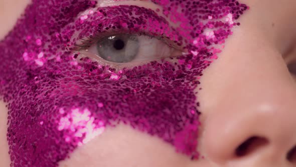 Macro Closeup of Womans Face with Glitter Eye Makeup in Shape of the Star