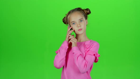 Baby Is Talking on the Phone with Her Mom. Green Screen. Slow Motion alt