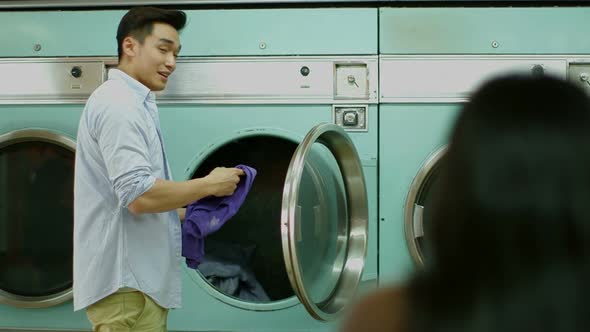 A Young Man and a Young Woman meet in a Launderette whilst doing their laundry