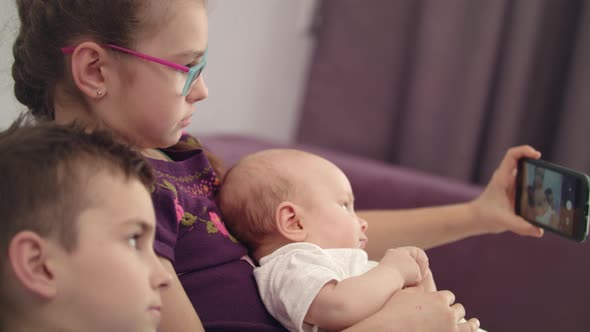 Children Take Selfie on Mobile Phone at Home alt