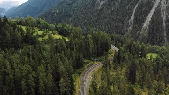 Top View Aerial Shot of Railway Track Going Through Majestic Summer Switzerland Alps Mountains alt