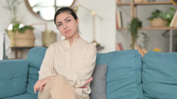 Indian Woman Sitting and Thinking on Sofa alt