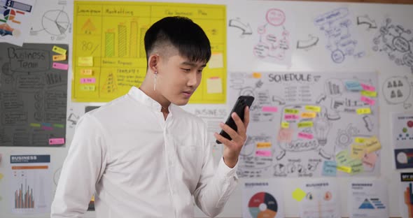 Happy man using smartphone alt