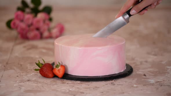 Cutting a Strawberry Mousse Cake with Pink Mirror Glaze