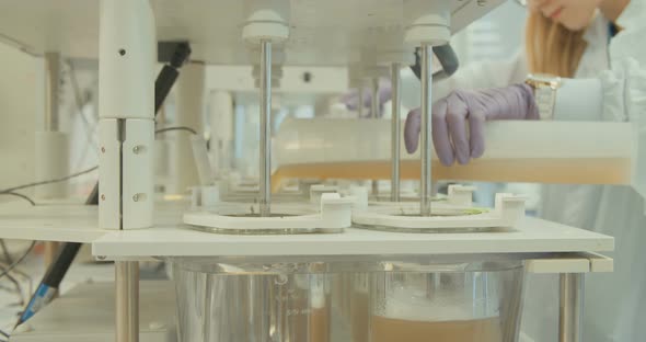 Scientist working in a pharmaceutical laboratory conducting experiments alt