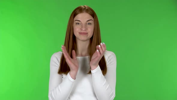 Portrait of Pretty Young Woman Is Clapping Her Hands Indifferent alt