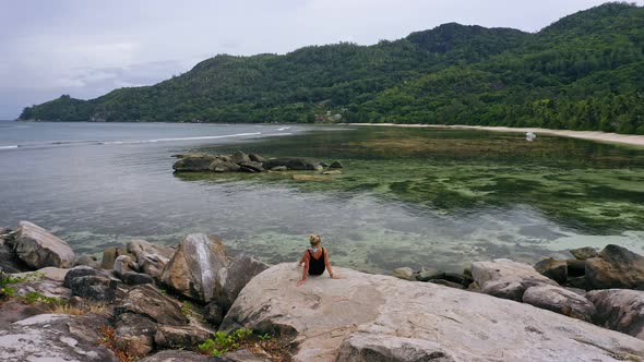 Aerial View of Blonde Girl Enjoying Exotic Nature Lagoon of Seychelles alt