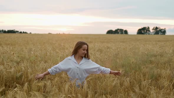 Romantic and Carefree Young Woman in Slow Motion Video Walking on Field Wheat Enjoying Freedom and alt