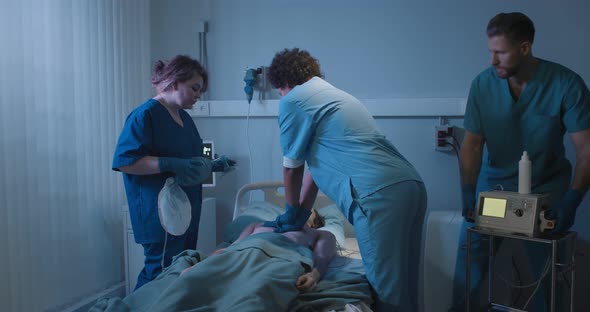 Medical Team Making Cardiopulmonary Resuscitation to Male Patient in Hospital alt