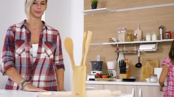 Dolly Slider  Footage of Young Daughter Helps Her Mother at the Kitchen alt