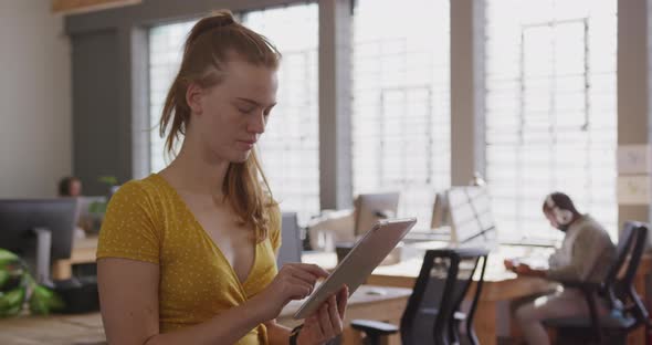 Young creative professionals working in a modern office alt