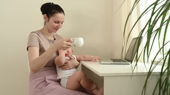 Young Mother Work Studying From Home with Laptop Computer During Quarantine Little Cute Toddler Baby