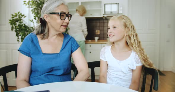 Grandmother and Granddaughter Talking at Home