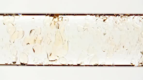 Macro Shot of Yellow Air Bubbles on White Background alt