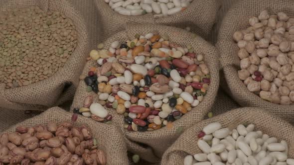 Dry mixed beans legumes falling in bowl at slow motion. Healthy Mediterranean diet food. Vegan or ve alt