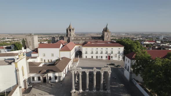 Aerial backwards view over square with an old roman temple in the middle. Evora, Portugal