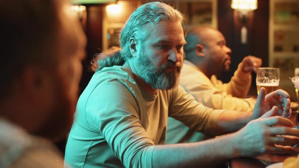 Male Friends Relaxing In Pub alt