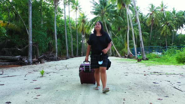 Female model sunbathing on paradise coast beach break by blue ocean with white sand background of th alt