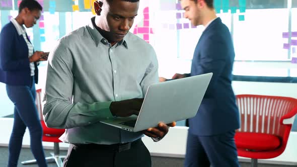 Business colleagues using laptop and digital tablet 4k alt
