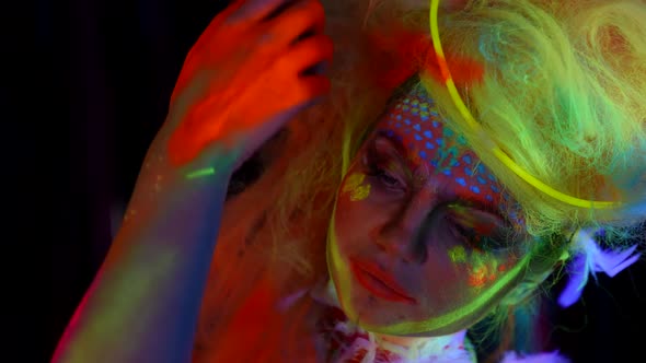 Amazing Beautiful Woman with Fluorescent Makeup on Face and Neon Hair Closeup Portrait alt
