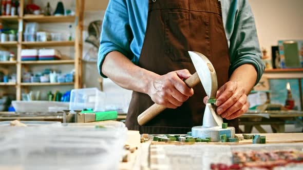 Young master with a hammer at work alt