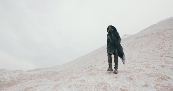Wide Angle Post Apocalyptic Female in Black Hooded Mantle Grunge Protective Gas Mask Walking on alt