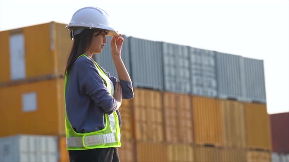 Worker woman checking and control loading containers box from cargo